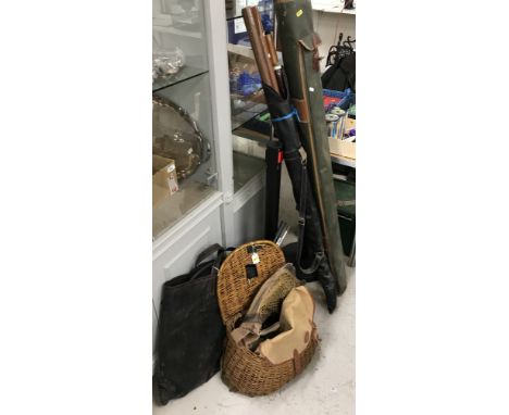 A collection of various fishing equipment including a cane creel, two canvas fishing bags, green plastic fishing box stool, k