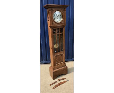 A 1930s oak cased long case clock, the three train movement with circular silvered dial and Arabic numerals over a bevel edge