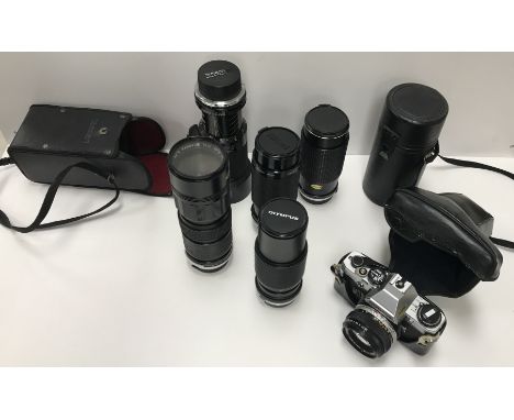 An Olympus OM10 35 mm camera together with five various lenses including Auto Panagor Tele Zoom lens, Kiron Macro lens, Tamro