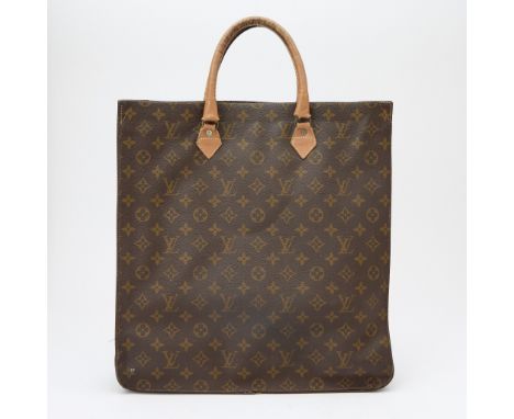 Dual brown leather top handles, coated monogram canvas, dark brown fabric interior with one side zippered pocket, signed Loui