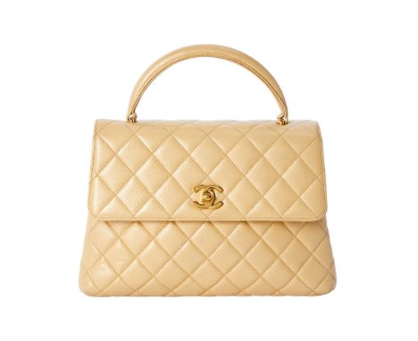 Top handle bag with gold-tone hardware and 'CC' turn lock closure, front flap opening to a light tan leather interior with si