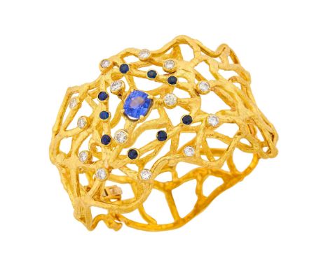 18 kt., one cushion-shaped modified step-cut sapphire weighing 3.16 cts., 9 round sapphires, 14 round diamonds ap. 1.95 cts.,