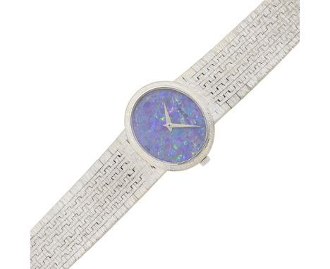 18 kt., mechanical, oval black opal numberless dial, case dia. ap. 28 x 24 mm., mesh bracelet, fold-over clasp, signed Piaget