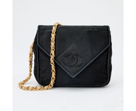 Quilted fabric with stiched double 'CC' on front flap, woven through chain strap with gold-tone leather, interior lined with 