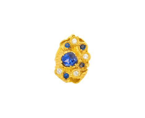 18 kt., one modified cushion-shaped modified step cut sapphire weighing 5.89 cts., 4 round sapphires, 4 round diamonds ap. .6