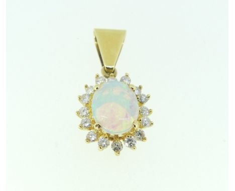 An opal and diamond oval Pendant, the centre stone surrounded by sixteen small diamonds, all mounted in unmarked yellow metal