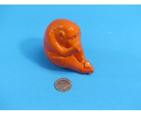 A rare Royal Worcester netsuke, modelled as an ape, decorated in orange, green printed mark, 2¾in (7cm) high.