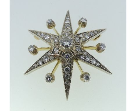 A six point diamond set Star Brooch, each ray set with three graduated diamonds and two small diamonds, with six knife edge r