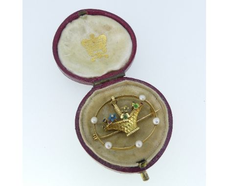 An attractive Brooch, in unmarked yellow metal, formed of an open circle set five seed pearls, the centre suspended with a ba