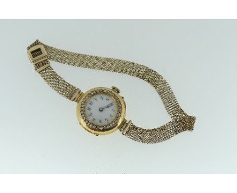 A continental 18ct gold and diamond set lady's Cocktail Watch, the circular white enamel dial with Arabic numerals surrounded