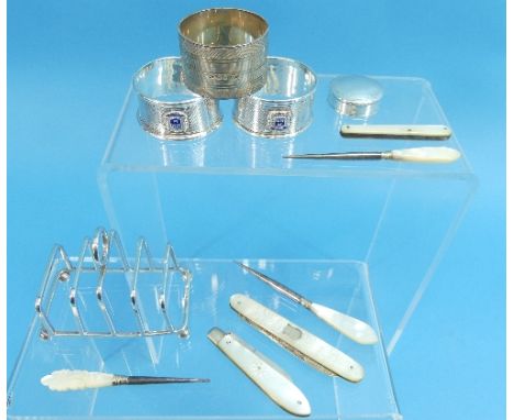 A small silver five bar Toast Rack, hallmarked Birmingham, 1936, together with a pair of silver napkin rings, hallmarked Birm