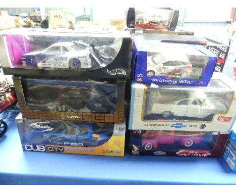 Twelve 1:18 scale die cast model vehicles, Burago, Hotwheels, Auto Art, etc, and four 1:10 scale American Chopper series cust