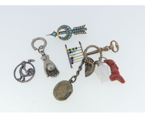 A foliate engraved split Ring, suspended with a key ring, a coral branch, a beaded abacus, an agate vase, and miniature hinge