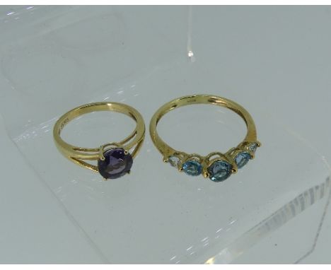 Three 9ct yellow gold Rings; one set circular facetted amethyst, one set five graduated blue topaz, the other cabochon blue s
