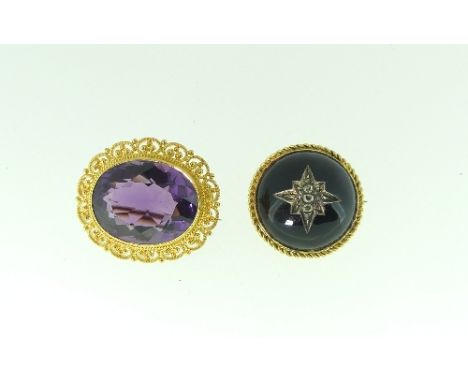 An oval Brooch, set in the centre with  a facetted amethyst, with a looped surround, marked on the reverse 14K, together with