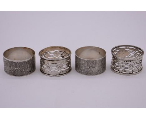 A pair of engine turned silver napkin rings, by&nbsp;W H Haseler Ltd, Birmingham 1924; together with two other silver napkin 