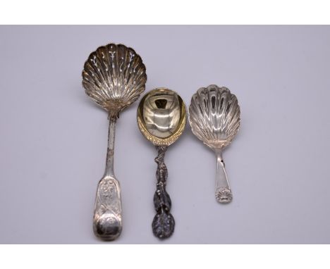 A silver shell caddy spoon,&nbsp;by&nbsp;Josiah Williams &amp; Co, London 1915; together with a silver sifter spoon; and anot