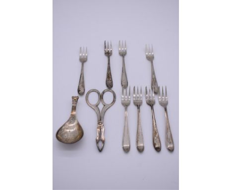 A set of eight continental white metal cake forks, 11.5cm; together with a German white metal caddy spoon, stamped 830, 9cm; 