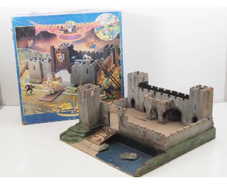 A BRITAINS 'Knights of the Sword' Lion Castle in original box together with a vintage wooden fort by BINBALL - F/G in F/G box