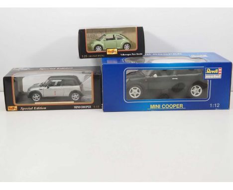 A group of large scale diecast cars comprising a 1:12 scale Mini Cooper by REVELL, a 1:18 scale Mini Cooper by MAISTO and a 1