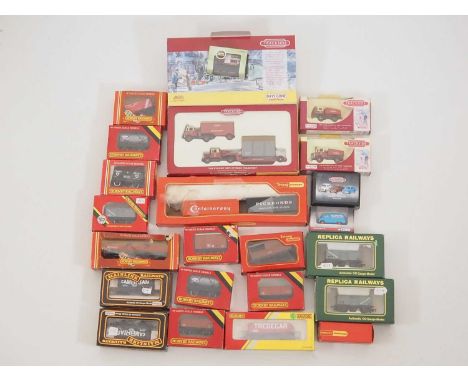A group of OO gauge boxed wagons by HORNBY, MAINLINE and others together with a small selection of 1:76 scale vehicles by COR