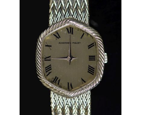 A lady's 18ct gold Audemars Piguet manual wind wrist watch,with hexagonal Roman dial, on integral 18ct gold strap, overall 16