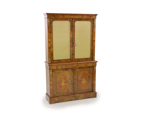 A Victorian ormolu mounted marquetry inlaid walnut bookcase,with moulded cornice and two glazed doors enclosing a later mirro