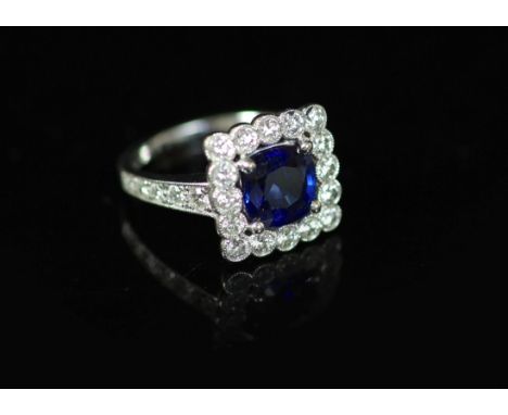 A modern 18ct white gold, sapphire and millegrain set diamond square cluster ring,the sapphire measuring approximately 8mm in