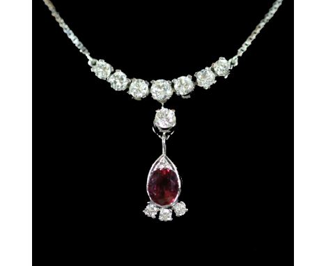 A modern Italian 18ct white gold, single stone oval cut ruby and eleven stone diamond set drop pendant necklace,the drop belo
