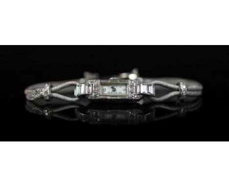 A lady's 1930's French Boucheron platinum and diamond set cocktail watch,and numbered 6823, with engraved inscription on case