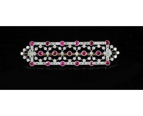 A 1920's/1930's style pierced gold and platinum, ruby and diamond chip millegrain set shaped oblong cluster brooch,52mm,, gro