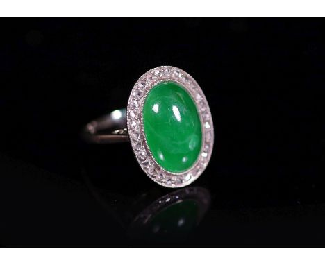 A 1920's 18ct white gold, oval cabochon jadeite and rose cut diamond millegrain set dress ring,jade dimensions 14.7mm by 10.5