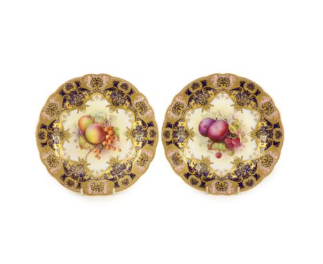 A pair of Royal Worcester fruit painted dessert plates, signed E. Phillips, c.1918,each within gilt-decorated cobalt blue and