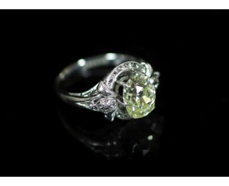 A white gold and oval cut solitaire diamond ring, in a raised claw setting,the stone weighing approximately 1.90ct, with an e