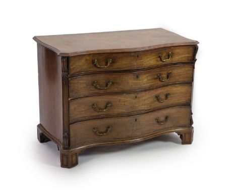 A George III Chippendale style mahogany serpentine commodewith moulded top and four graduated long drawers flanked by canted 