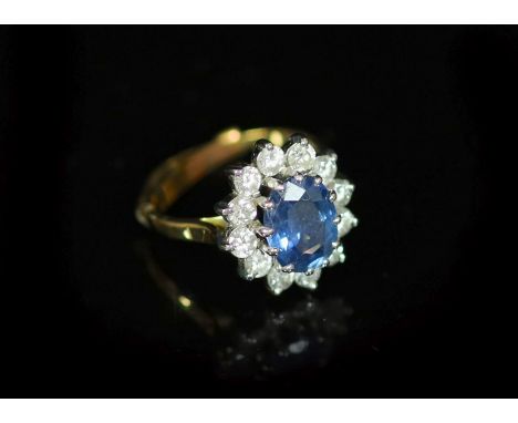 A modern 18ct gold, sapphire and diamond set oval cluster ring,with 9ct ring sizer, size L, gross weight 4.5 grams.