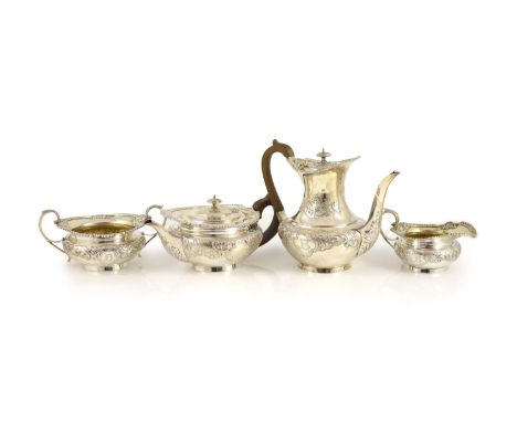 An Edwardian embossed silver circular four piece tea and coffee service by Edward Barnard &amp; Sons Ltd,with engraved initia