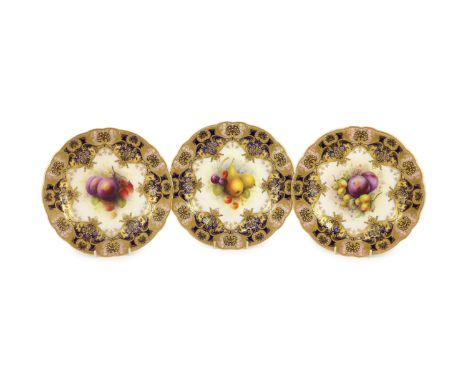Three Royal Worcester fruit painted dessert plates, signed A. Shuck and E. Phillips, c.1918,each within gilt-decorated cobalt