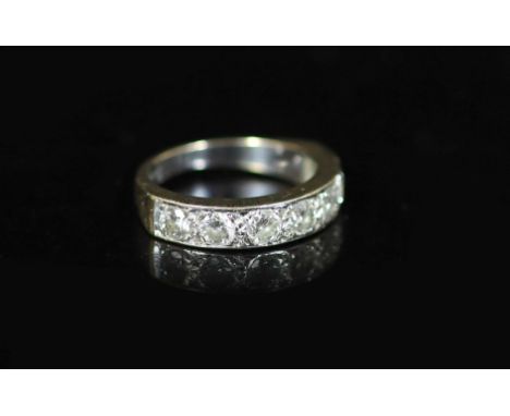 A modern white gold and channel set seven stone diamond half hoop ring,size P/Q, gross weight 6.4 grams.