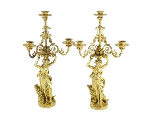 A pair French ormolu four light candelabrawith scrolling foliate branches supported by female grape pickers, on naturalistic 