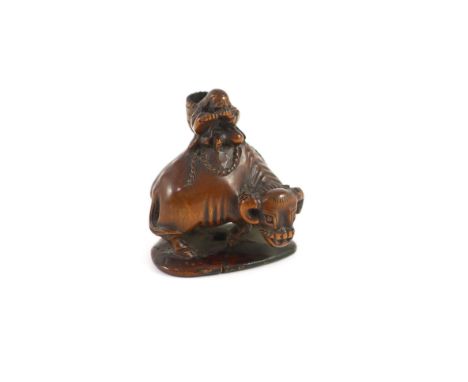 A Japanese boxwood netsuke of Semimaru playing the flute and riding upon an ox, School of Tomotada, early 19th century,signed