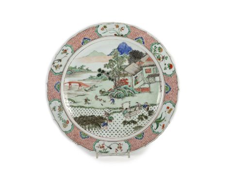 A Chinese famille verte charger, Kangxi period (1662-1722),finely painted with a farmstead scene including boys ushering chic