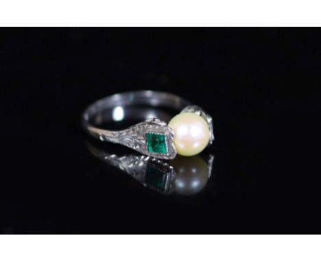 A mid 20th century white gold, cultured pearl and emerald set three stone ring,size N, gross 2 grams.