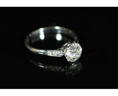 An 18ct white gold and single stone diamond ring,with six stone diamond set shoulders, the central stone weighing approximate