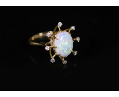 An 18ct gold, single stone oval white opal and eight stone diamond set modernist ring,size M, gross 5.7 grams.