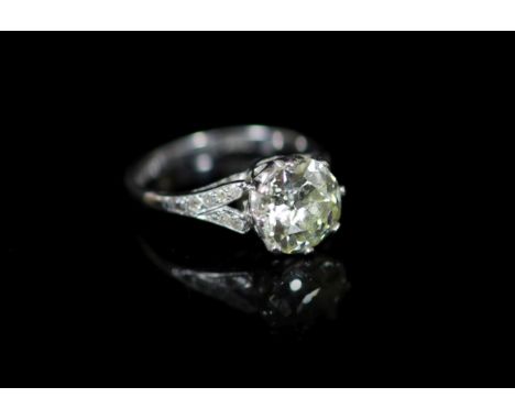 A 20th century 18ct white gold and platinum set single stone diamond ring, with diamond set shoulders,the central round brill