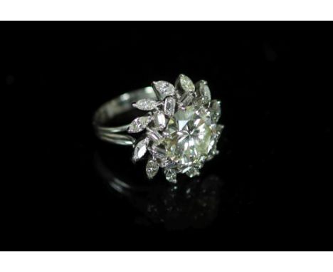 A platinum and single stone diamond ring, with baguette and marquise cut diamond foliate setting,the central stone weighing a