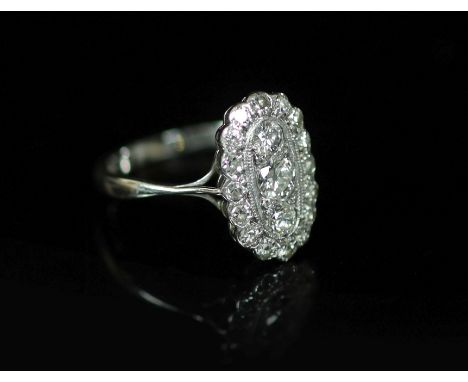 A 1940's 18ct white gold and diamond set oval cluster ring,size O/P, gross weight 3 grams.