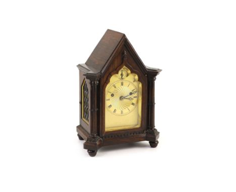 An early Victorian gothic revival rosewood mantle clock,with Gothic lancet case and gilt engine turned dial with strike silen