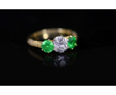 A Tiffany &amp; Co gold, single stone diamond and two stone demantoid garnet set ring,with carved shoulders, size I/J, gross 